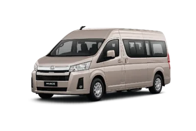 Toyota Hiace Premio coklat muda metallic tampak serong depan dan samping untuk layanan sewa Hiace Bogor dengan driver profesional