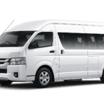 Toyota Hiace Commuter Luxury putih tampak serong depan dan samping untuk layanan sewa Hiace Luxury Bogor dengan driver profesional